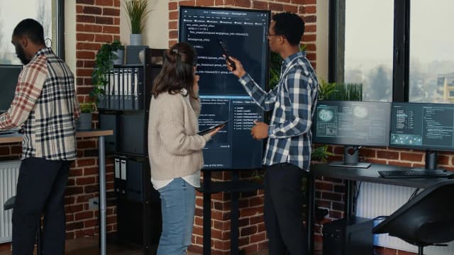 Software development team using DevOps automation tools for deployment